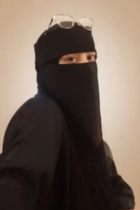Teacher Barirah smiling, wearing modest attire, looking friendly and approachable for online Quran and Arabic classes.